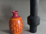 two vases sitting next to each other on a table