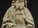 a statue of a man with a beard holding a bowl