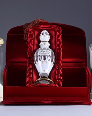 a bottle of perfume sitting inside of a red box