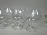 several empty wine glasses are lined up on a table