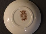 a white plate with a brown design on it