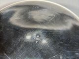 a metal pan with a metal lid sitting on a stove