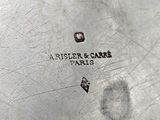 a close up of a silver plate with a logo on it