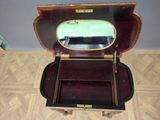 a small wooden box with a mirror on top of it