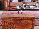 a wooden box sitting on the floor in a living room