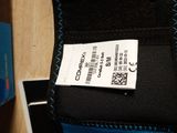 a black and blue wallet with a price tag on it