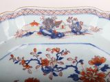 a blue and white plate with orange flowers on it