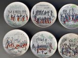 four plates with a drawing of a group of people on them