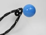 a blue ball that is being held by a pair of scissors