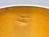 a close up of a gold ring with a flower on it