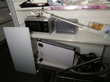 a microwave and a toaster on a shelf in a room