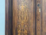 a large wooden armoire with intricate carvings on it