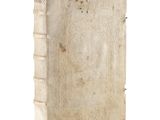 an old book that is sitting on a white surface