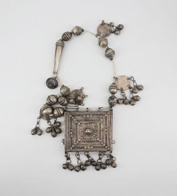 a silver necklace with silver beads and a square pendant