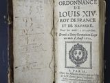 an old book with writing on it sitting on top of a table