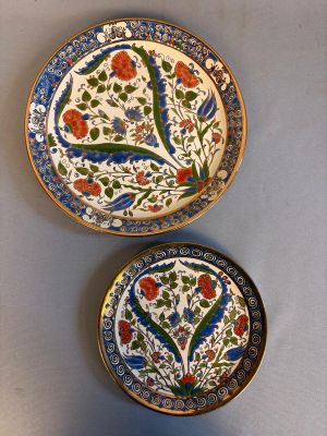 trois assiettes ornées de motifs floraux sont posées sur une table