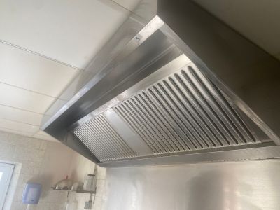 une photo d'une hotte aspirante en acier inoxydable dans une cuisine