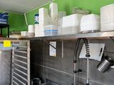 a kitchen with a lot of dishes on the shelves