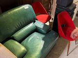 a man standing next to a couch and chair in a living room