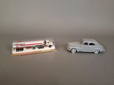two toy cars sitting next to each other on a table