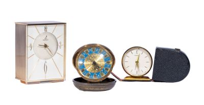 trois horloges différentes posées les unes à côté des autres sur une table