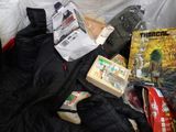a pile of clothing and other items on a bed