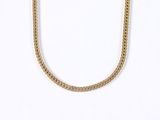 a close up of a gold chain necklace on a white background