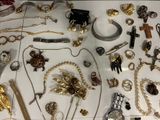 many different types of jewelry displayed on a table