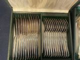 a lot of silverware in a case on the table