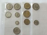 a lot of coins that are in a plastic container