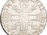 a close up of a coin with a cross on it