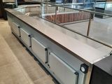 a large counter with a glass top in a restaurant