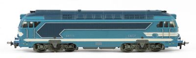 a blue train that is on the tracks on a white background