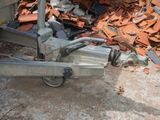 a machine that is sitting on the ground next to a pile of rubble