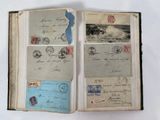 an open book with stamps on it on a white surface