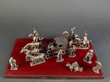 a silver figurine of a horse drawn carriage