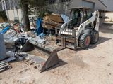 a small tractor that is parked in front of a building