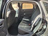 the back seats of a car with the door open in a parking lot