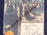 une pièce de monnaie dans un sachet en plastique posé sur une surface bleue