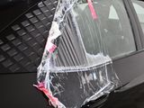 a car that has been wrapped in plastic and is parked on the side of the road