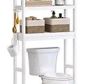 des toilettes blanches surmontées d'une étagère, à côté d'une plante en pot