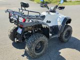 a white four wheeler atv parked on the side of the road