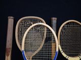 two tennis rackets sitting next to each other on a table