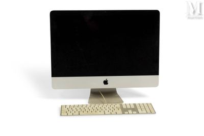 a computer with a keyboard and monitor on a white surface