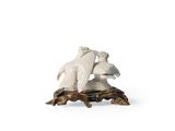 a figurine of two birds sitting on a tree branch