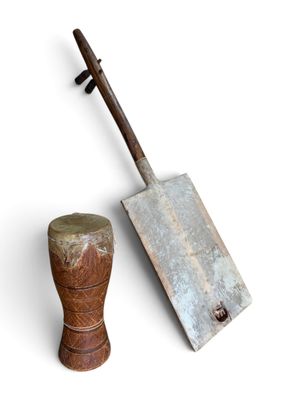 an old shovel and a wooden block on a white background