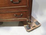 a wooden chest of drawers with metal handles on it