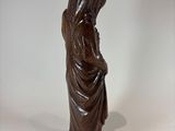 statue of a woman with a hood on her head and a hood on her head