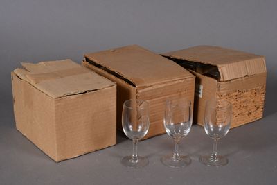 three empty wine glasses and a cardboard box on a table