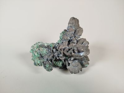 crystal cluster on a white surface with a white background